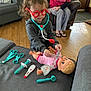 accessories, architecture, baby, boy, building, child, clothing, couch, face, footwear, furniture, glasses, head, indoors, livingroom, male, person, room, scissors, shoe