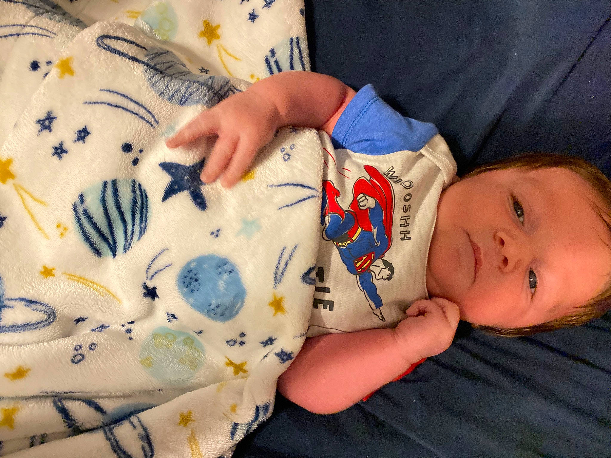 Dexter is registered to the contest to win money with this photo: art, baby, baby_toddler_clothing, child, comfort_food, finger, hand, happy, linens, nail, pattern, person, room, skin, sleeve, smile, t_shirt, textile, toddler, toy