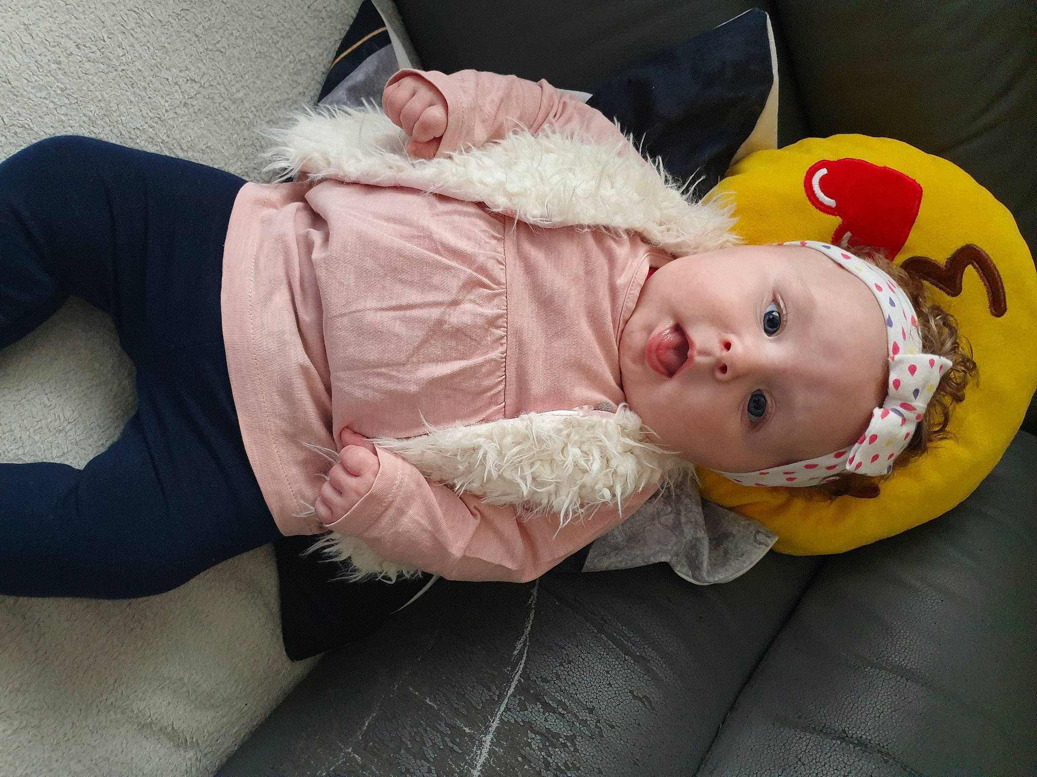 Lindsay participe au concours pour gagner de l'argent avec cette photo : baby, baby_products, baby_toddler_clothing, cheek, child, comfort, fur, hat, headwear, human_leg, knee, lap, person, sitting, sleeve, thigh, toddler