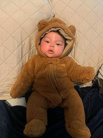 Alaya joined the competition — help win amazing prizes! baby, baby_toddler_clothing, cheek, child, comfort, face, flooring, fur, happy, headwear, human_body, nose, person, personal_protective_equipment, sitting, skin, sleeve, smile, textile, toddler