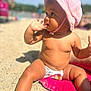 Lila participe au concours pour gagner de l'argent avec cette photo : baby, child, beach, sand, sunhat, towel, diaper, sunny, outdoor, summer, cute, sitting, skin, portrait, daylight, vacation, young, hand, face, curious
