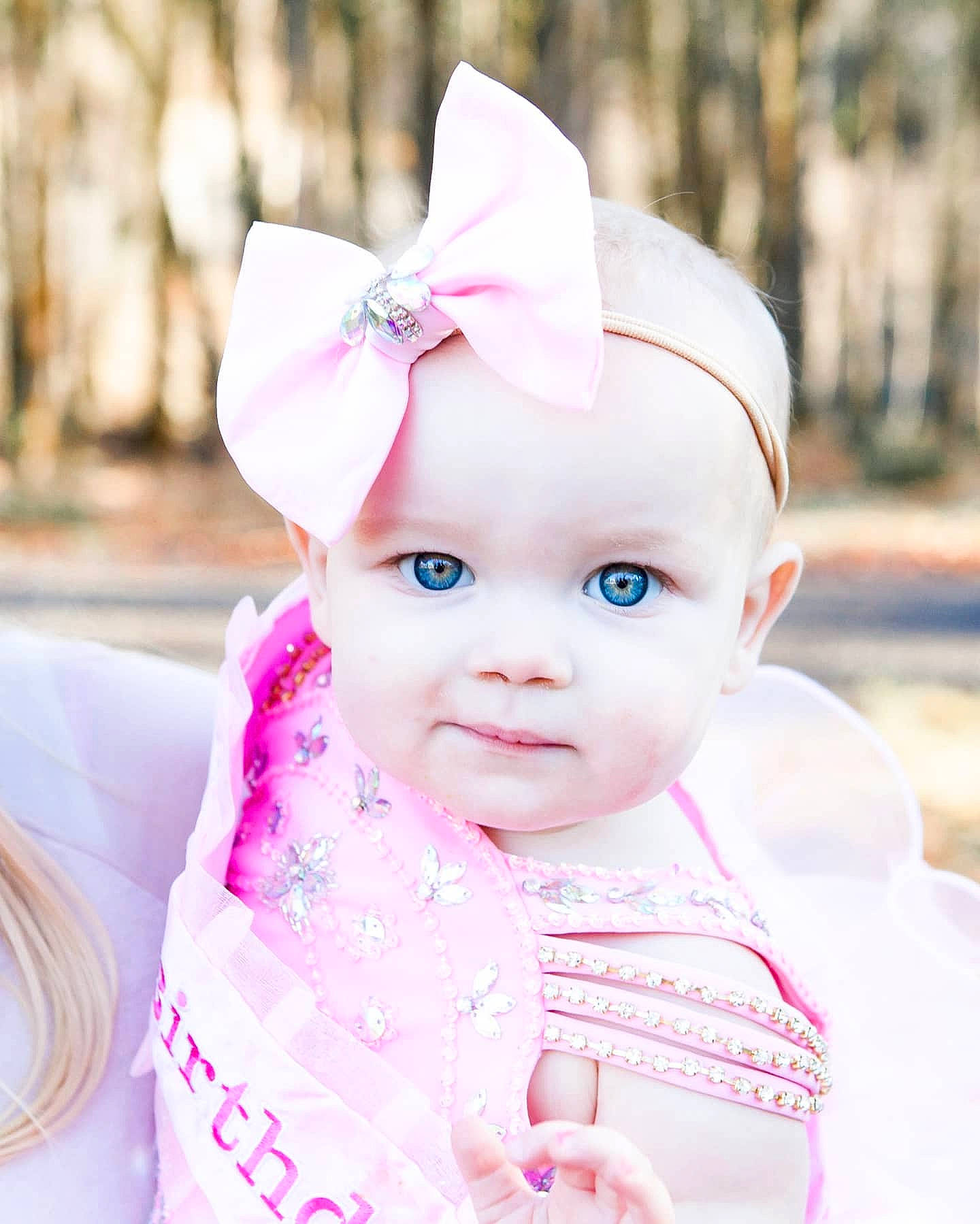 Carter is registered to the contest to win money with this photo: baby, baby_toddler_clothing, cheek, child, child_model, costume_accessory, ear, embellishment, fawn, hair_accessory, headband, headpiece, headwear, lip, mouth, nose, peach, person, pink, portrait_photography