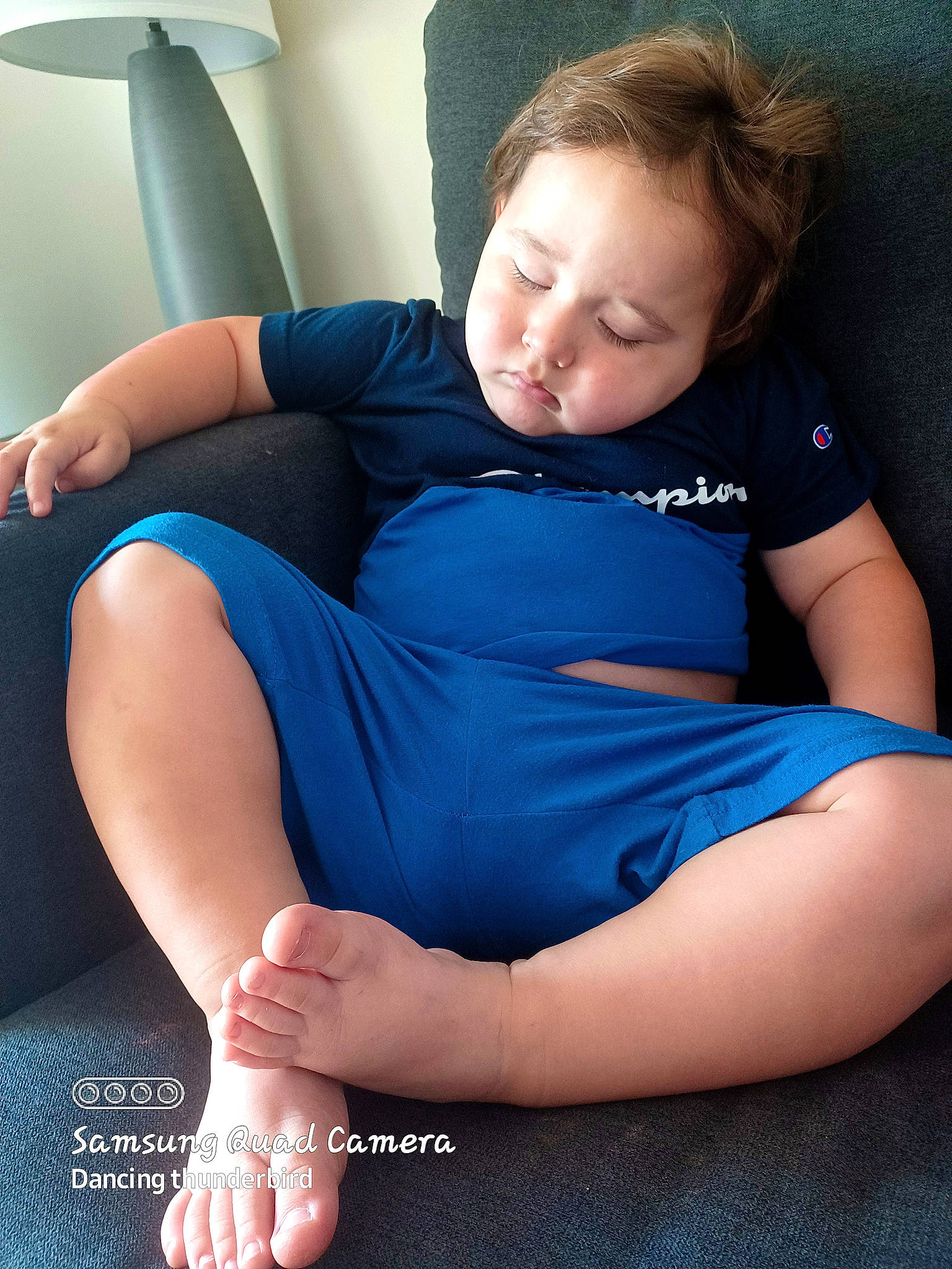 Ryland is registered to the contest to win money with this photo: arm, azure, baby_toddler_clothing, comfort, elbow, finger, flash_photography, hair, hand, human_body, joint, knee, lap, leg, muscle, neck, person, shoulder, skin, t_shirt