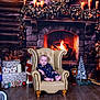 baby, armchair, fireplace, wreath, candles, christmas_decorations, pajamas, wood_floor, gift_boxes, nutcracker, toy, holiday, indoor, cozy, warm_lighting, face, person, floor, decor, sitting