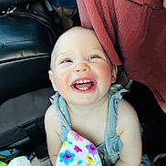 Brentley is registered to the contest to win money with this photo: baby, child, smile, teeth, blanket, colorful, happy, face, infant, clothing, person, cute, joy, portrait, indoors, playful, skin, head, eyes, expression