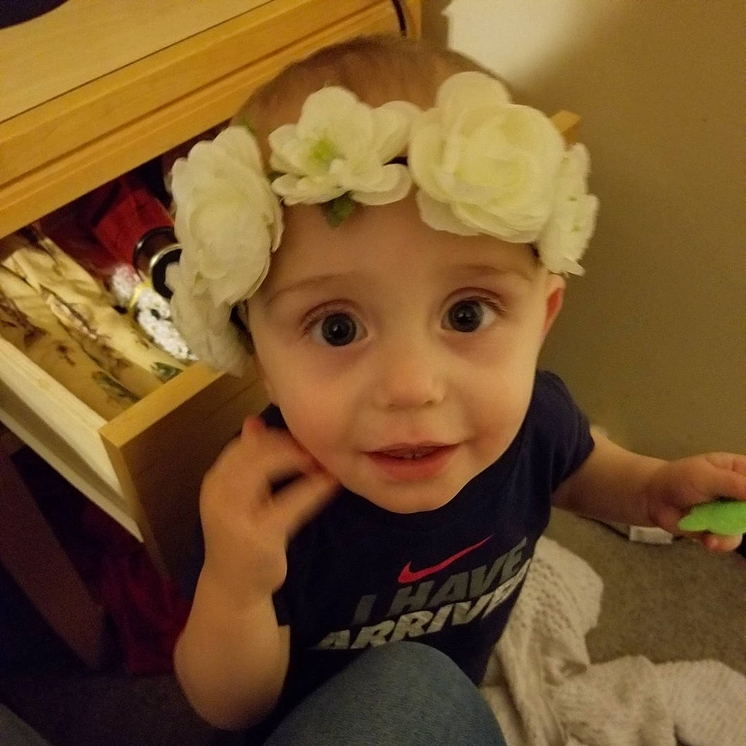 Ashtyn is registered to the contest to win money with this photo: baby, cheek, child, cool, ear, eye, face, fashion_accessory, flower, forehead, hair_accessory, hand, head, headband, headgear, headpiece, headwear, nose, person, plant