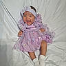 baby, infant, smile, dress, headband, socks, sitting, happy, cute, portrait, child, fabric, white_background, clothing, toddler, young_child, indoors, person, sparkle, purple