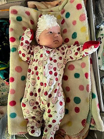 Snow-white is registered to the contest to win money with this photo: baby, baby_products, baby_toddler_clothing, child, costume, headwear, linens, mammal, nightwear, pattern, peach, person, pink, plush, room, sleeve, stuffed_toy, t_shirt, textile, toddler