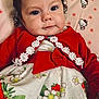 Matilda joined the competition — help win amazing prizes! baby, infant, child, red_clothing, dress, flower_pattern, strawberry_pattern, blanket, hello_kitty, cute, portrait, face, smile, indoors, young_child, happy, person, soft_toys, floral_design, cozy