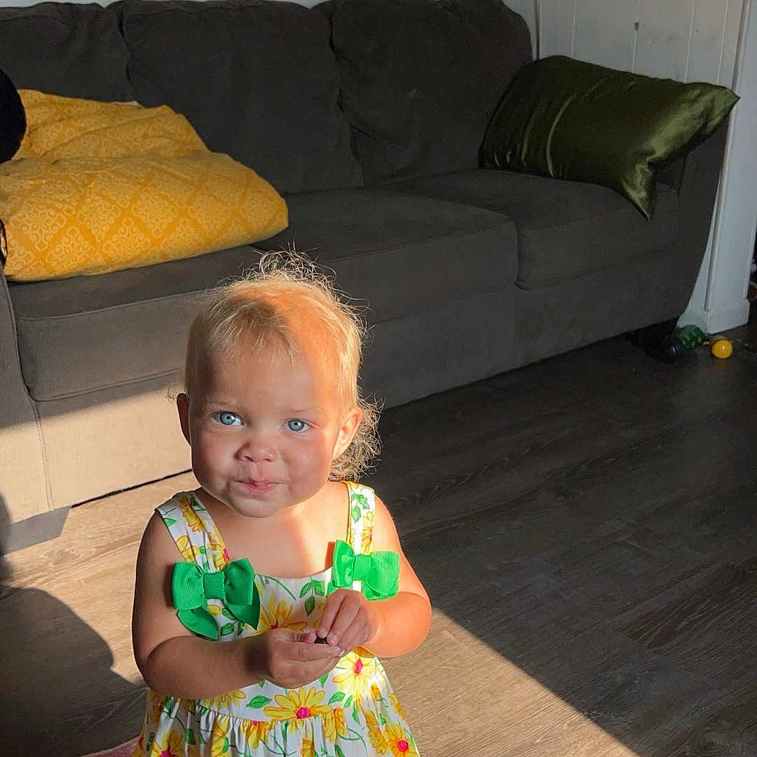 Everly is registered to the contest to win money with this photo: architecture, building, child, clothing, couch, cushion, dress, face, female, furniture, girl, head, homedecor, indoors, livingroom, person, photography, portrait, room, sitting