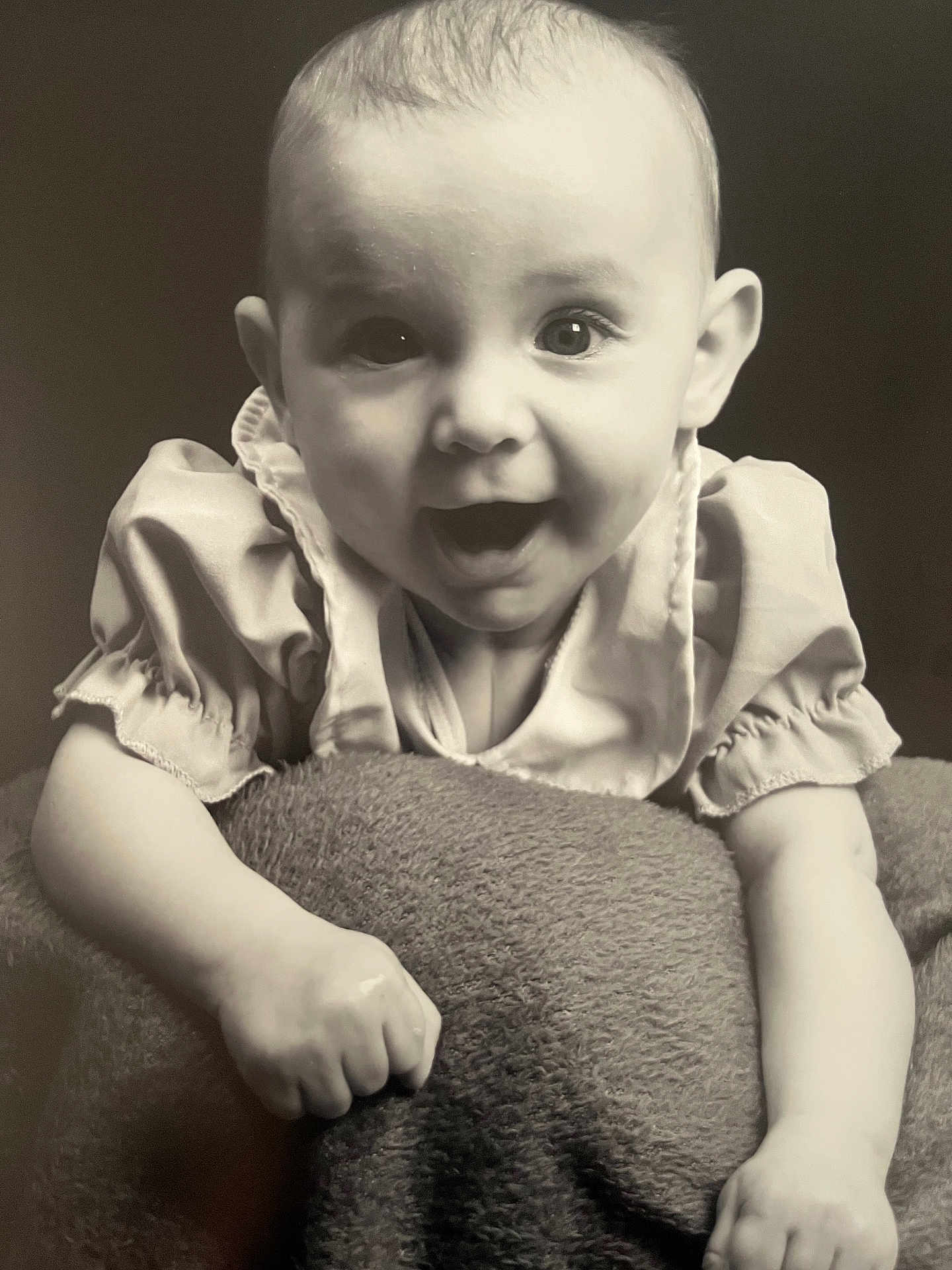 Delilah-Mae is registered to the contest to win money with this photo: baby, infant, smiling, portrait, black_and_white, clothing, blanket, face, happy, cute, child, studio, expression, young, person, hands, texture, eyes, monochrome, closeup