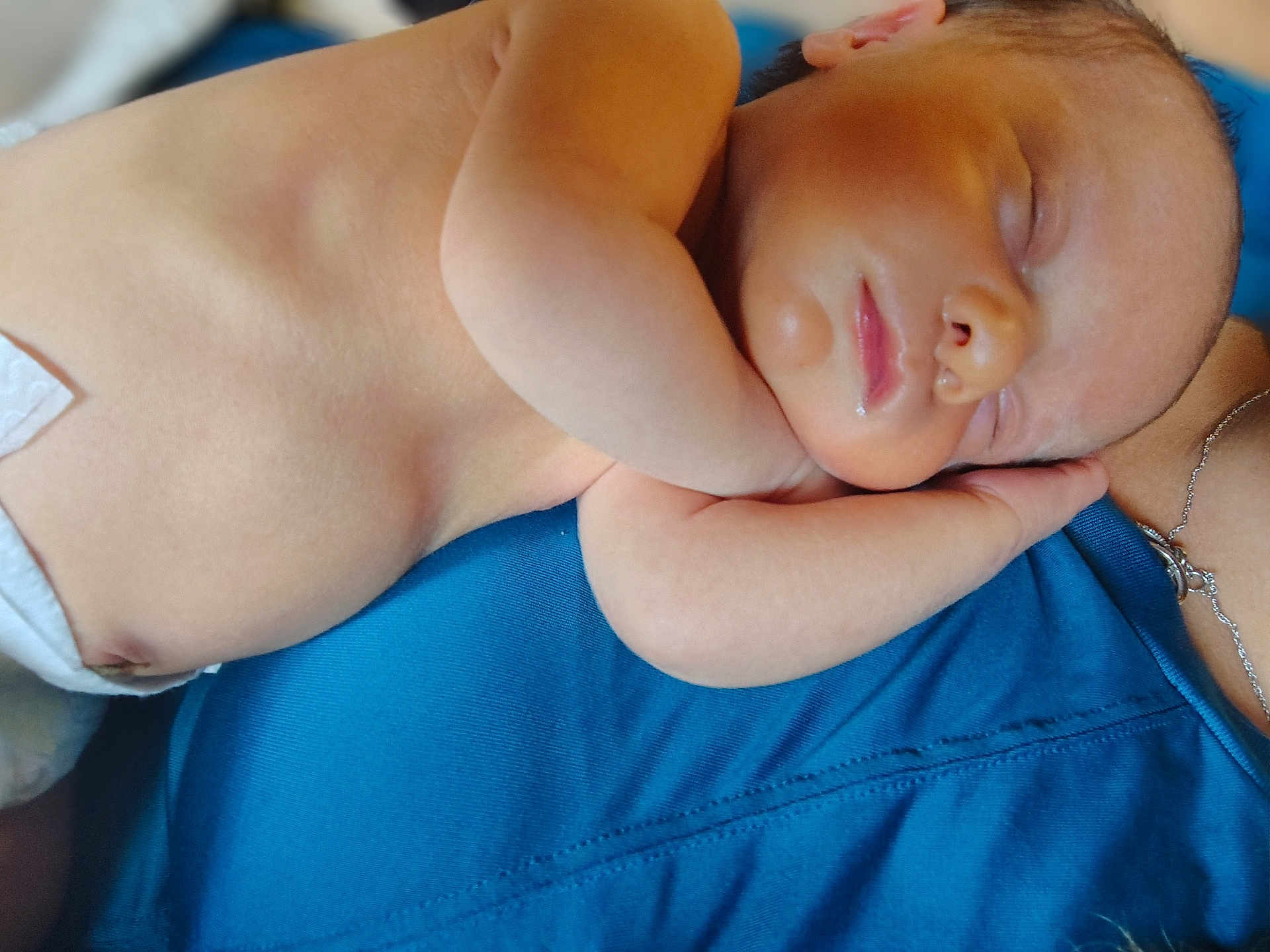 Jaxson joined the competition — help win amazing prizes! baby, newborn, sleeping, skin, arm, diaper, person, blue_clothing, necklace, closeup, peaceful, resting, human, infant, portrait, soft_light, relaxation, cuddling, face, body