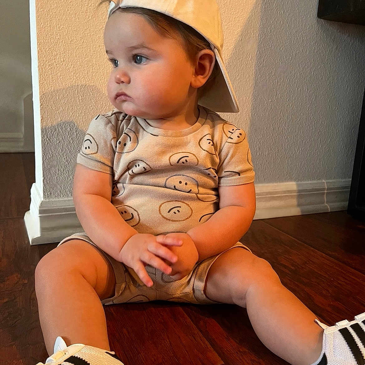 Brayden joined the competition — help win amazing prizes! baby, baseballcap, cap, clothing, face, footwear, hardwood, hat, head, indoors, person, photography, portrait, sandal, shoe, shorts, sitting, sleeve, sneaker, wood
