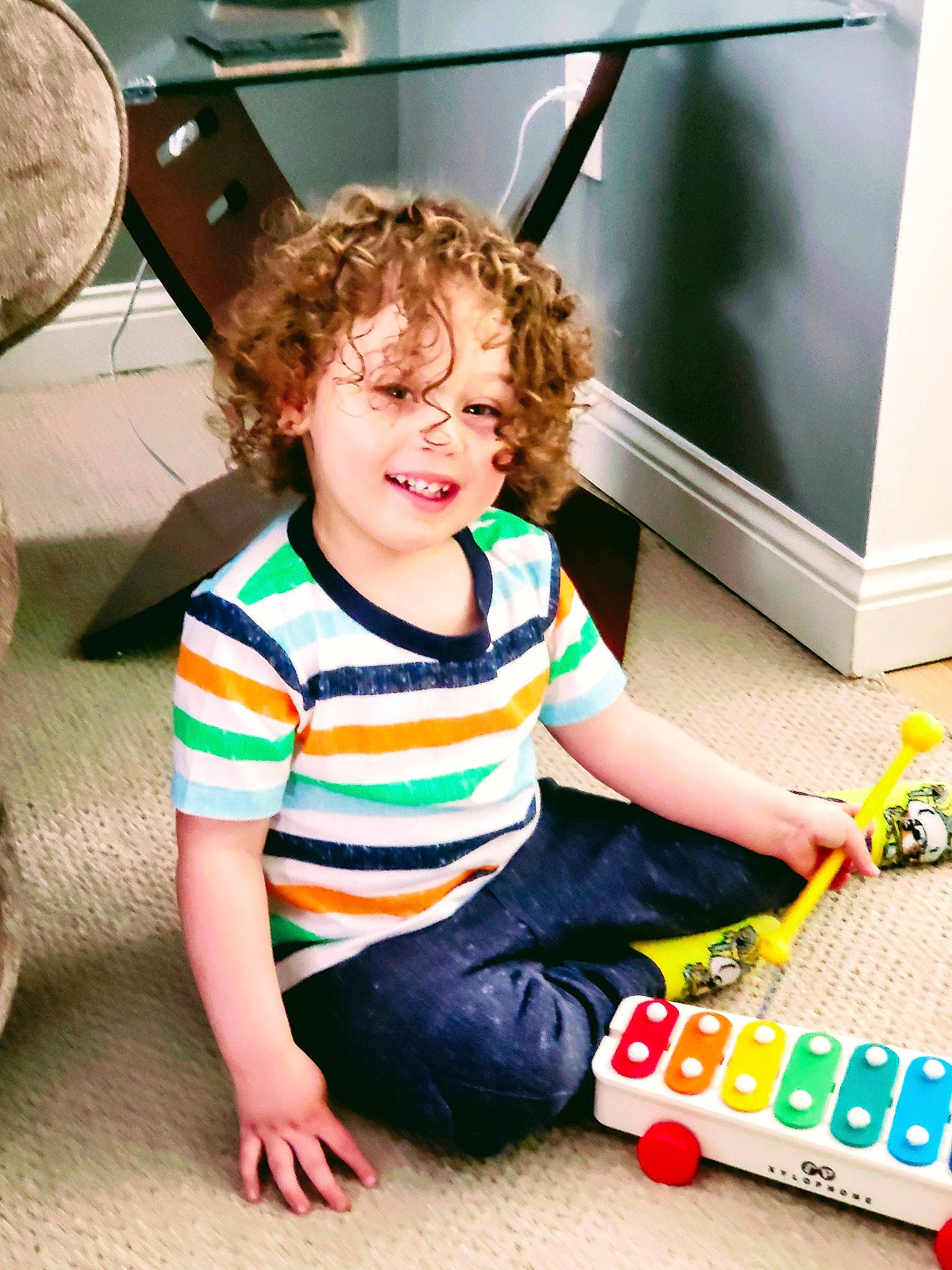 Milan is registered to the contest to win money with this photo: box, child, computer_keyboard, computer_monitor, flooring, fun, gadget, happy, home_appliance, leisure, person, play, recreation, room, sitting, smile, t_shirt, toddler, toy, toy_block