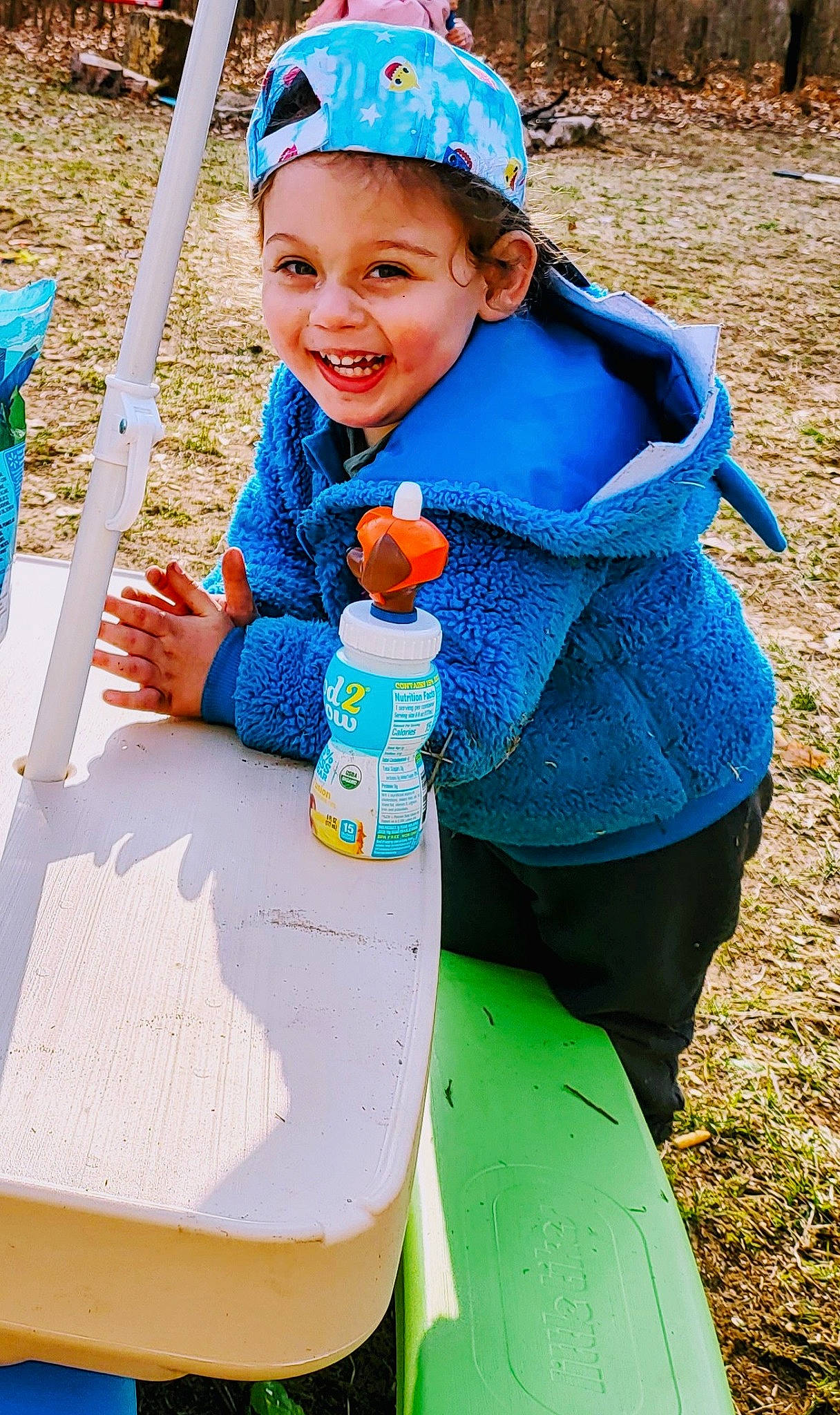 Milan joined the competition — help win amazing prizes! adaptation, blue, bottle, child, electric_blue, fun, grass, green, happy, headwear, joy, leisure, people, person, personal_protective_equipment, plastic_bottle, recreation, smile, summer, textile