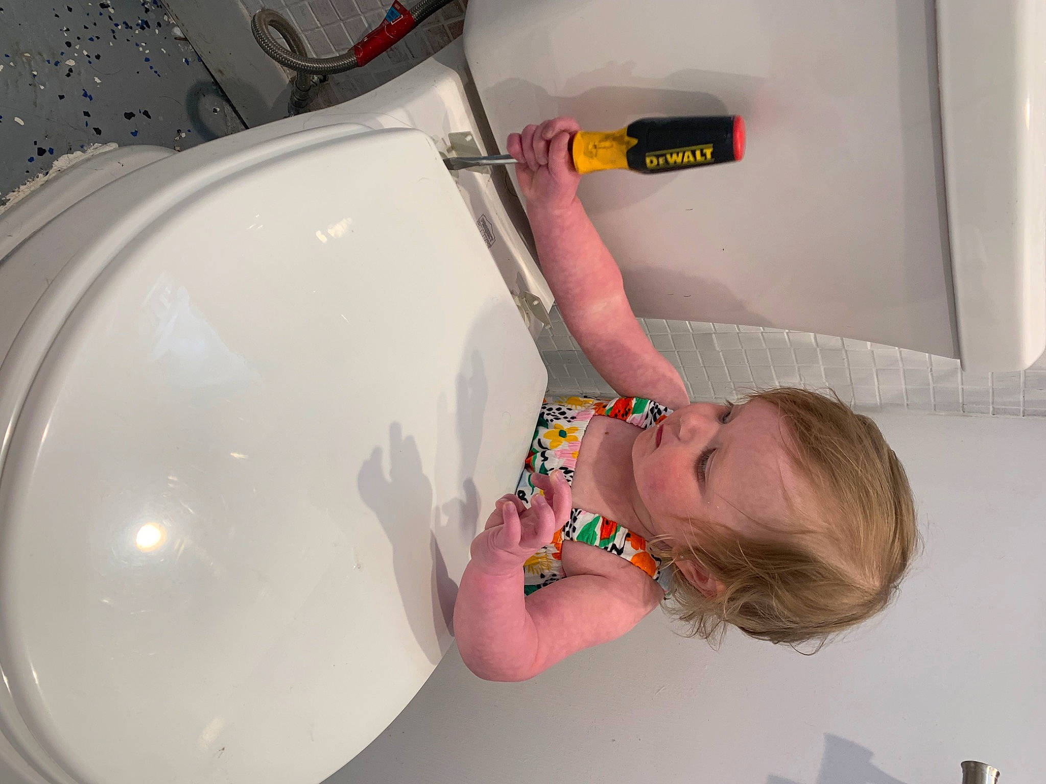 Roxanne is registered to the contest to win money with this photo: arm, bathing, cleanliness, elbow, finger, flooring, fluid, fun, gas, hand, household_supply, person, plastic, plumbing, plumbing_fixture, room, sink, tap, toddler, water