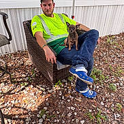 Savage joined the competition — help win amazing prizes! man, dog, chair, outdoor, casual, pet, wicker_chair, blue_footwear, crocs, yellow_shirt, jeans, grass, leaves, rocks, water_bowl, relaxed, tattoo, hat, sunlight, shadow
