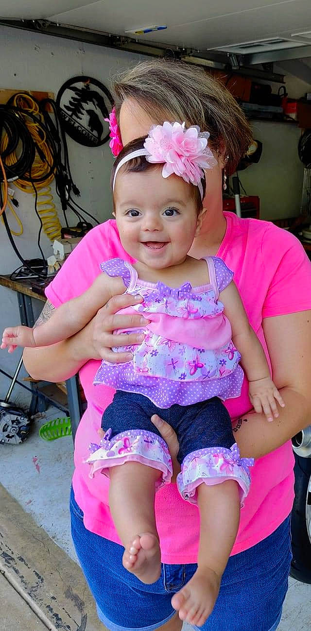 Rosalia is registered to the contest to win money with this photo: baby, baby_toddler_clothing, cheek, child, ear, fashion_accessory, hair_accessory, headband, headgear, headwear, joy, person, pink, purple, smile, toddler