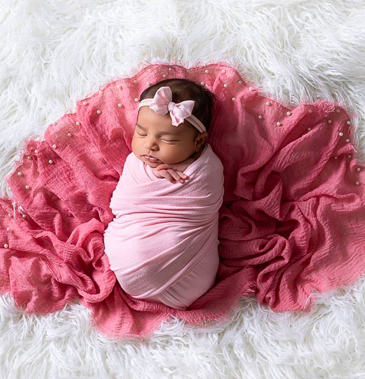 Sania is registered to the contest to win money with this photo: arm, baby, baby_toddler_clothing, comfort, dress, eye, face, hand, head, headgear, headpiece, headwear, magenta, person, petal, pink, product, purple, skin, sleeve