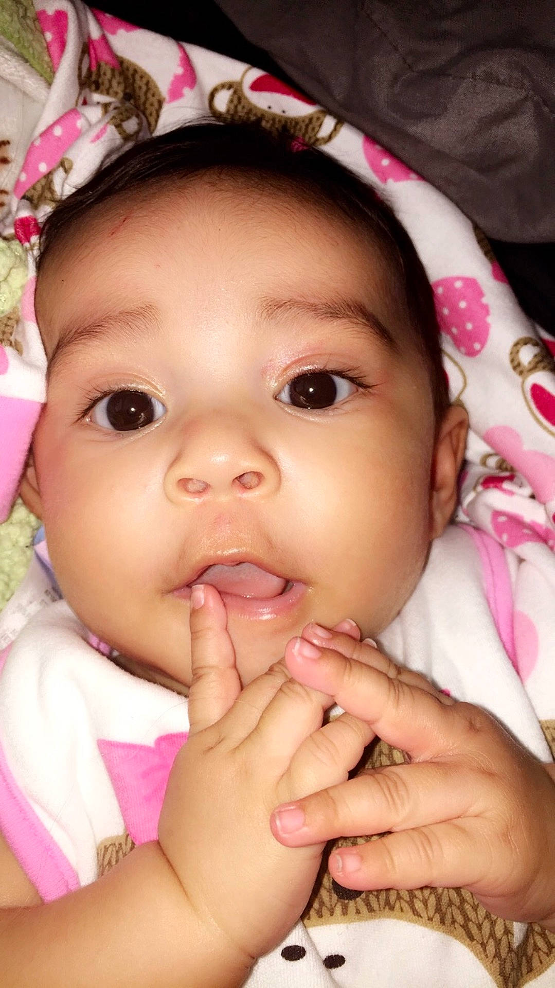 Melina Marie is registered to the contest to win money with this photo: beauty, black_hair, cheek, child, close_up, eye, eyebrow, face, finger, girl, hand, head, infant, lip, mouth, nose, person, pink, skin, smile