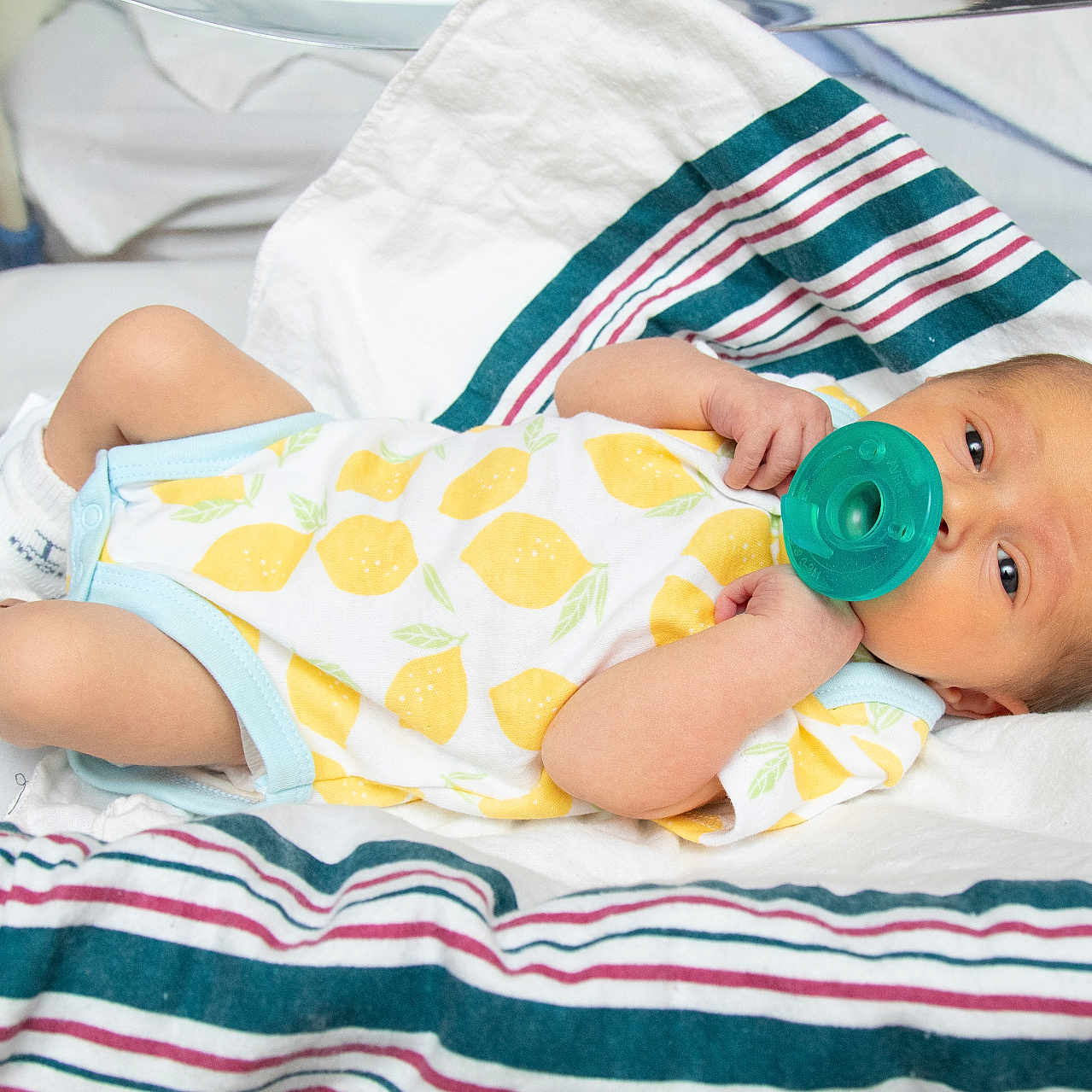 Thomas Ricci Jr is registered to the contest to win money with this photo: baby, baby_clothing, blanket, cute, face, hospital, hospital_bassinet, infant, lemon_pattern, lying_down, newborn, onesie, pacifier, resting, skin, sleepy, small_arms, small_legs, socks, striped_blanket