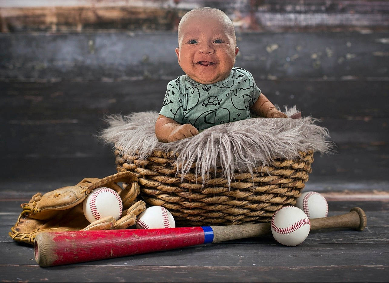 Athan is registered to the contest to win money with this photo: baby, basket, child, event, flash_photography, fun, grass, happy, hat, joy, leisure, mammal, people_in_nature, person, portrait_photography, recreation, sitting, smile, storage_basket, toddler