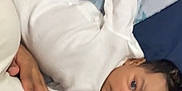Jasani joined the competition — help win amazing prizes! baby, child, infant, blanket, star_pattern, blue_blanket, white_clothing, lying_down, striped_pants, adult_hand, bed, resting, curious_expression, indoor, person, family, cozy, soft_texture, casual, closeup