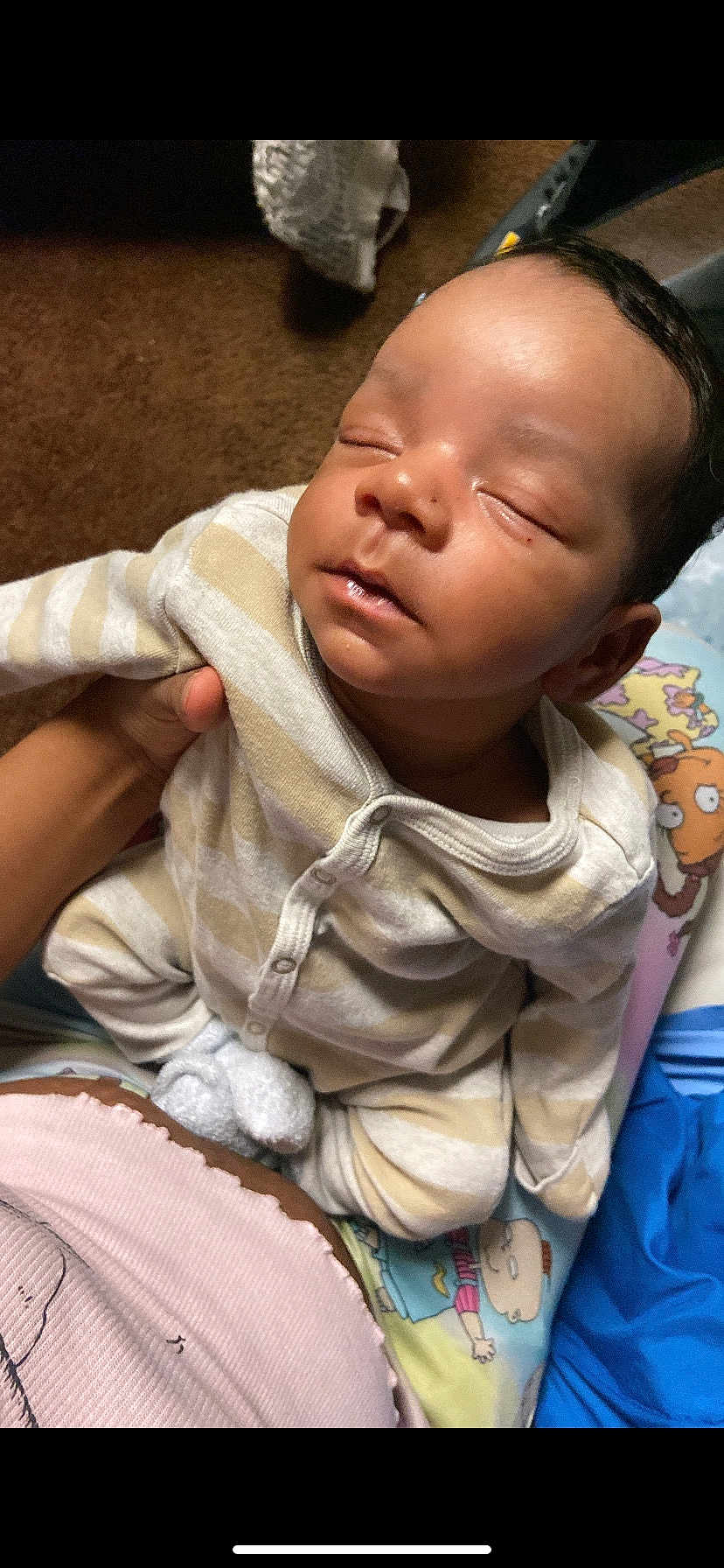 Jasani is registered to the contest to win money with this photo: baby, sleeping, pajamas, striped_clothing, hand, blanket, cartoon, bedtime, infant, cute, sleep, child, person, soft_toys, indoors, comfort, peaceful, rest, close_up, skin