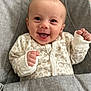Ava-Mae is registered to the contest to win money with this photo: baby, child, clothing, comfort, cozy, cute, expression, face, gray, hands, happy, human, indoor, infant, leopard_print, onesie, portrait, seat, smiling, young