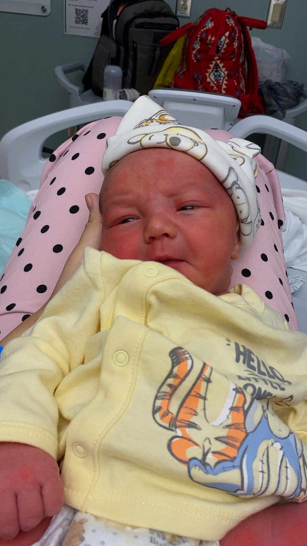 Charles joined the competition — help win amazing prizes! newborn, baby, infant, yellow_outfit, hat, polka_dot, pink_pants, hand, hospital_bed, hospital_room, cartoon_print, person, face, clothing, bed, indoor, resting, cute, toddler, medical