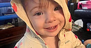 Ellie joined the competition — help win amazing prizes! baby, candid, casual_clothing, child, closeup, cozy, cute, expression, furniture, happy, heart_pattern, hoodie, indoors, living_room, person, portrait, smiling, television, toddler, warm_lighting