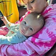 Ellie joined the competition — help win amazing prizes! baby, woman, child, car, seat, pink_hoodie, tie_dye, holding, affection, love, portrait, casual_clothing, indoor, seatbelt, glasses, sunlight, face, head, earrings, candid