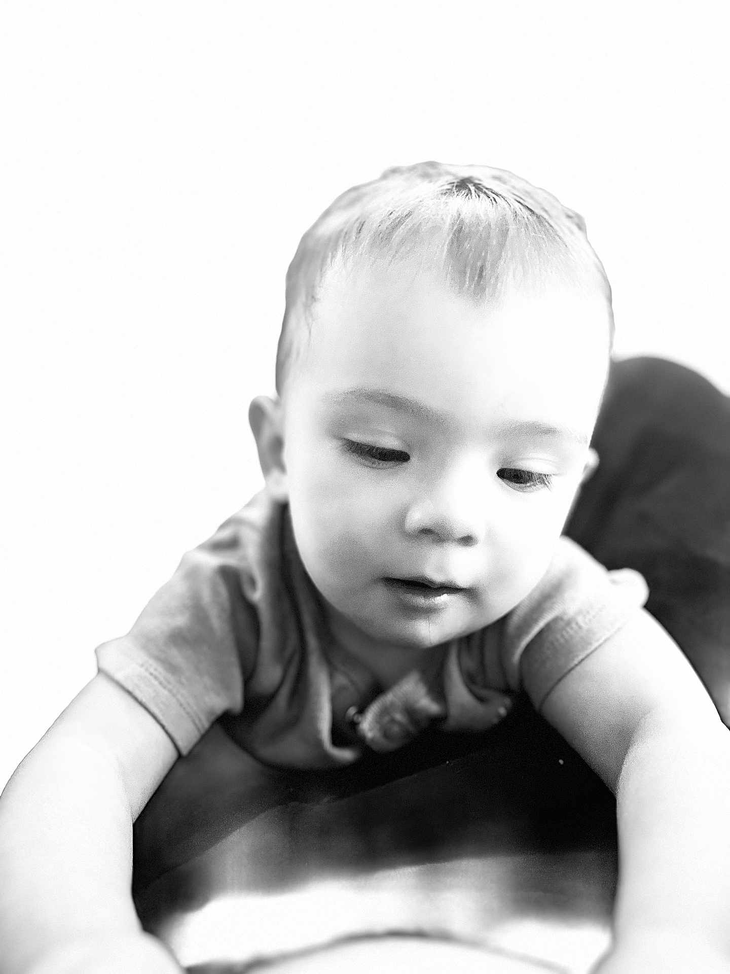 Ellie is registered to the contest to win money with this photo: child, toddler, baby, face, portrait, black_and_white, close_up, curious, expression, soft_lighting, short_hair, clothing, sleeve, skin, young, person, indoor, monochrome, cute, innocent