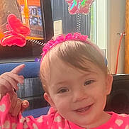 Ellie joined the competition — help win amazing prizes! arm, baby, butterfly, child, cute, expression, face, furniture, hair, hand, happy, headband, indoor, person, pink_clothing, portrait, seat, smiling, toddler, window
