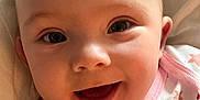 Ellie is registered to the contest to win money with this photo: baby, babywear, blanket, child, closeup, cute, eyes, face, happy, head, infant, mouth, onesie, pink, portrait, skin, smiling, stars, white, young