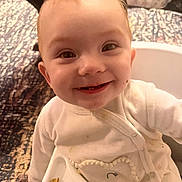 Ellie joined the competition — help win amazing prizes! baby, child, smiling, high_chair, food, messy, indoor, face, happy, clothing, person, infant, cute, tableware, feeding, sitting, expression, head, eyes, mouth