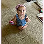 Amelia is registered to the contest to win money with this photo: baby, child, indoor, carpet, toy, headband, blue_outfit, sitting, cute, girl, person, floor, couch, cushion, holding, looking_up, infant, play, pink, young_child