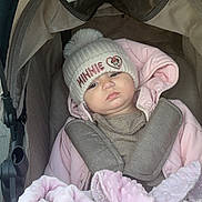 Martina participe au concours pour gagner de l'argent avec cette photo : baby, child, stroller, hat, pink_jacket, blanket, cold_weather, winter_clothing, cozy, infant, cute, outdoor, bundle, face, portrait, warm, person, child_in_stroller, mickey_mouse, serious_expression
