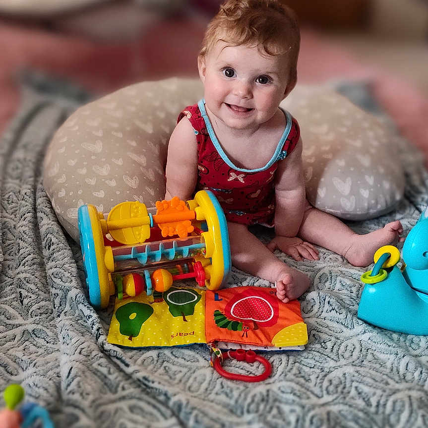 Scarlett joined the competition — help win amazing prizes! baby, bed, blanket, bodypart, couch, cushion, face, finger, furniture, hand, happy, head, homedecor, newborn, person, photography, portrait, quilt, smile, toy