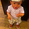Alexander joined the competition — help win amazing prizes! toddler, child, boy, striped_cap, white_shirt, striped_shorts, brown_shoes, wooden_floor, cookie, indoor, standing, curious_expression, snack, cute, young_child, person, portrait, casual_clothing, smiling, looking_up