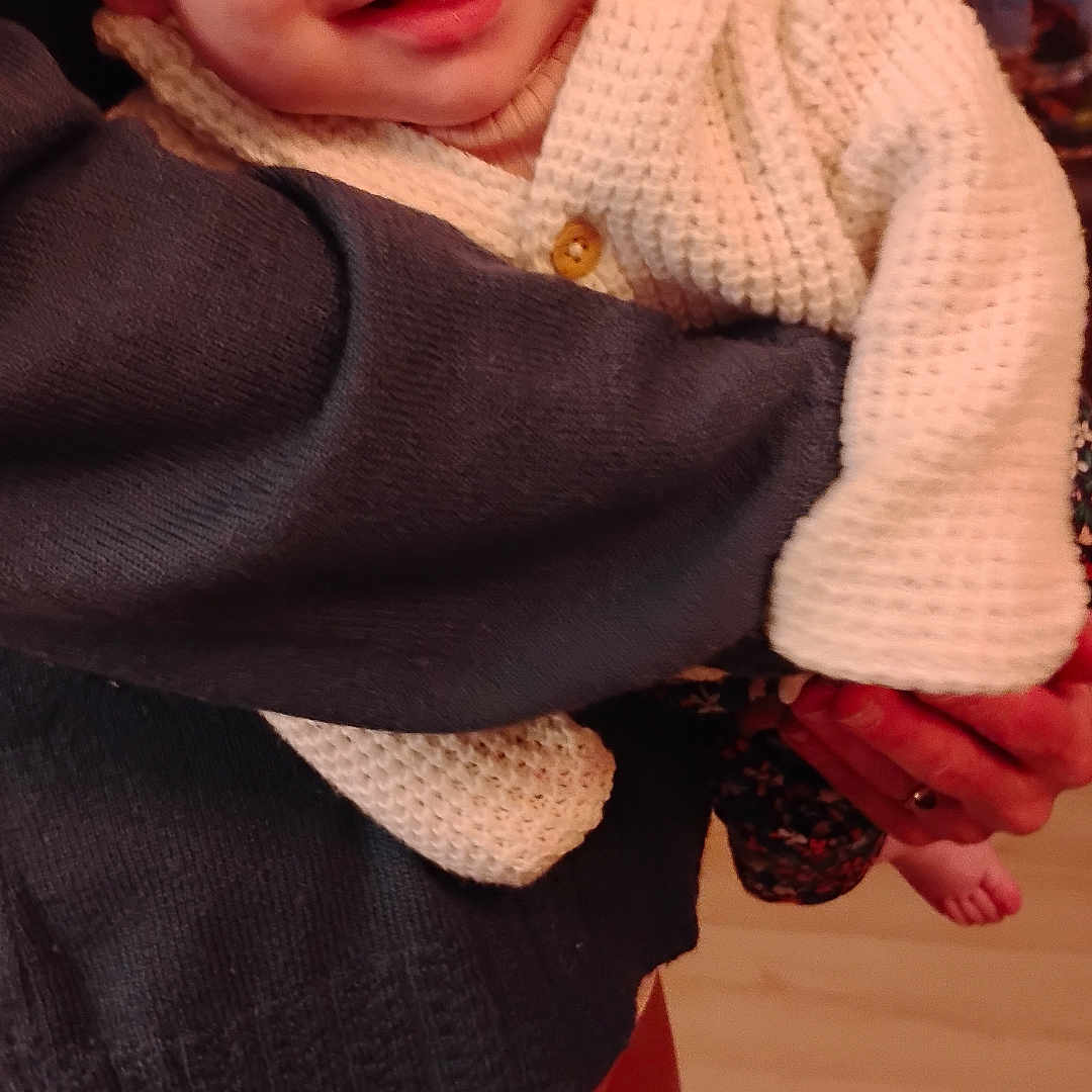 Ruby-Rose joined the competition — help win amazing prizes! adult, baby, child, closeup, clothing, cozy, face, hand, happy, holding, indoor, infant, knitwear, pants, person, phone, pocket, smile, sweater, warm_lighting