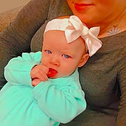 Ruby-Rose is registered to the contest to win money with this photo: baby, woman, child, headband, bow, blue_eyes, clothing, sitting, couch, patterned_pants, portrait, face, skin, hand, home, casual, smile, curly_hair, indoor, cozy