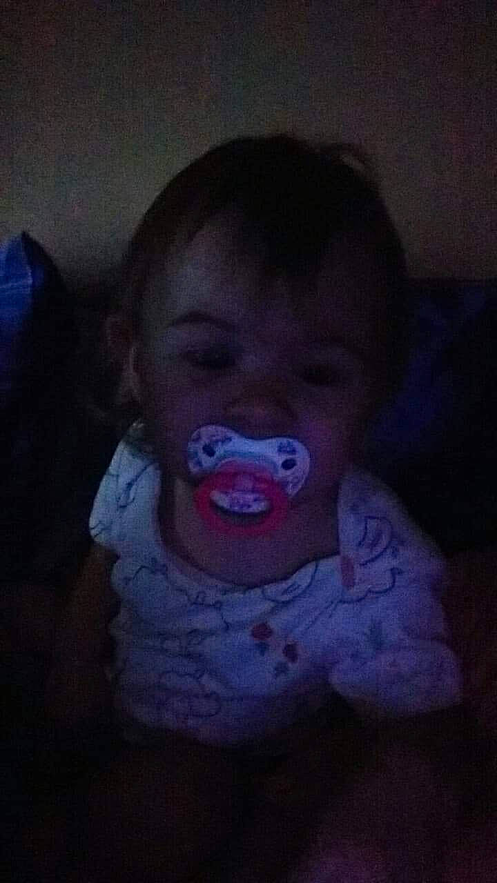 Karolina is registered to the contest to win money with this photo: baby, baby_toddler_clothing, cheek, child, cloud, darkness, eyelash, flesh, fun, happy, iris, jaw, lip, mouth, nose, person, purple, room, sitting, sweetness