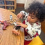 Harlow is registered to the contest to win money with this photo: child, toddler, curly_hair, playing, toy_animals, table, indoor, sweater, minnie_mouse, plastic_toys, brown_horse, black_and_white_cow, pig, yellow_chair, wooden_table, concentration, cute, person, young_child, preschool