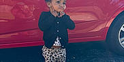 Harlow joined the competition — help win amazing prizes! toddler, child, car, red_car, pavement, sidewalk, reflection, black_cardigan, leopard_print_pants, white_shoes, outdoor, playful_expression, curly_hair, earrings, person, photography, daylight, parking_lot, keys, handbag