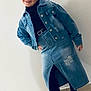 child, smiling, denim_jacket, denim_skirt, black_tights, black_shoes, posing, indoor, floor_tiles, white_wall, fashion, casual, young_girl, confident, portrait, full_body, standing, happy, clothing, accessories