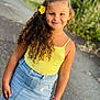 Sarah a rejoint le concours — aidez-le/la à gagner de superbes lots ! child, girl, smile, curly_hair, yellow_flower, yellow_tank_top, denim_skirt, bracelet, outdoor, paved_path, nature, greenery, portrait, standing, happy, casual_clothing, sunlight, fashion, summer, cute
