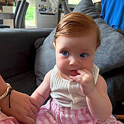 Giuseppa a rejoint le concours — aidez-le/la à gagner de superbes lots ! baby, child, indoor, couch, hand_holding, blue_eyes, striped_skirt, white_top, cute, portrait, living_room, furniture, person, skin, hair, face, sitting, infant, home, family