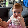 baby, child, indoor, couch, hand_holding, blue_eyes, striped_skirt, white_top, cute, portrait, living_room, furniture, person, skin, hair, face, sitting, infant, home, family