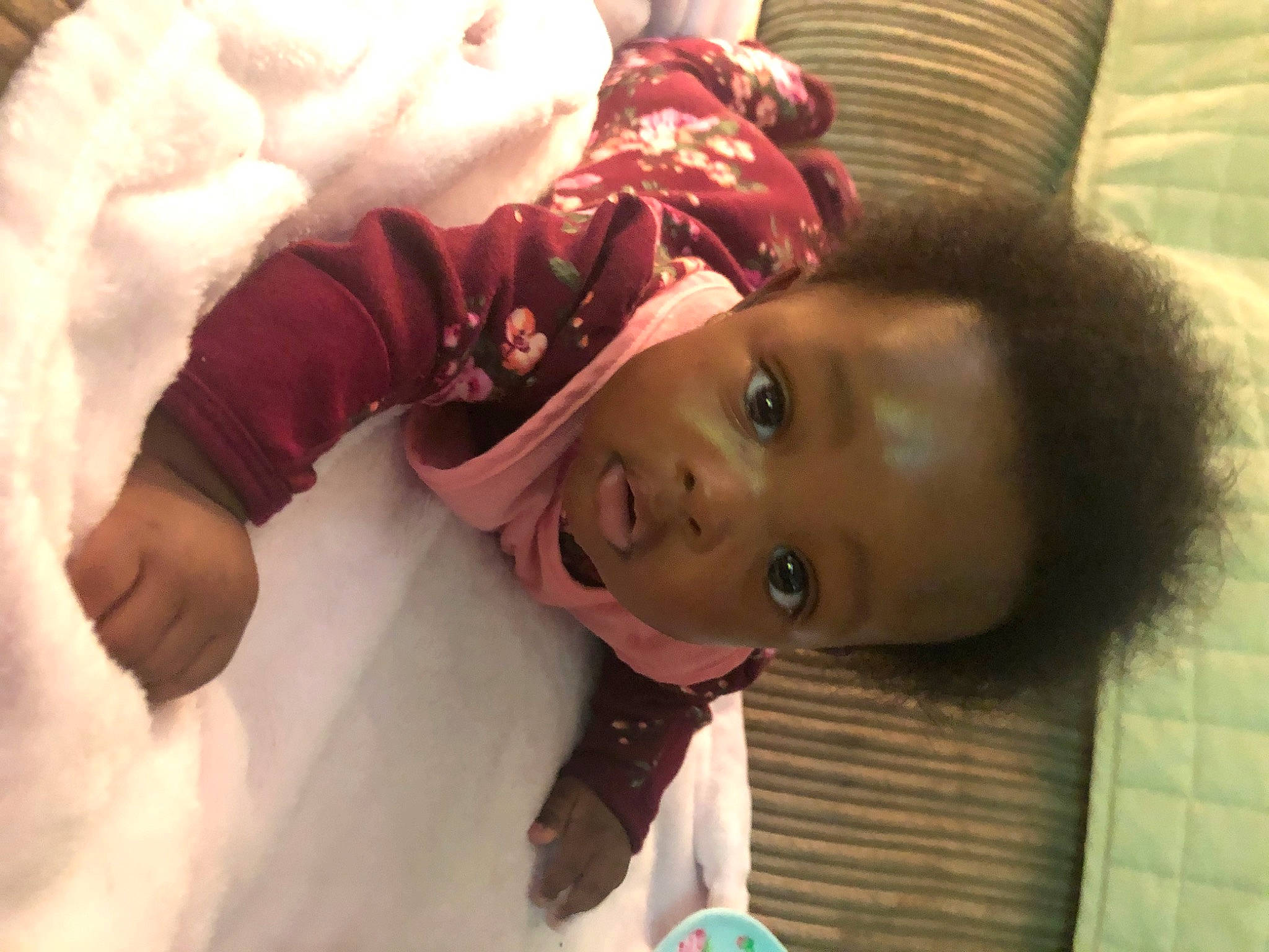 Neilani is registered to the contest to win money with this photo: arm, baby, baby_toddler_clothing, cheek, child, comfort, eye, eyelash, fun, happy, head, linens, lip, mouth, nose, person, room, skin, sleeve, textile